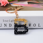 Carsine Black Pompom 26 Alphabets Keychain gold / B